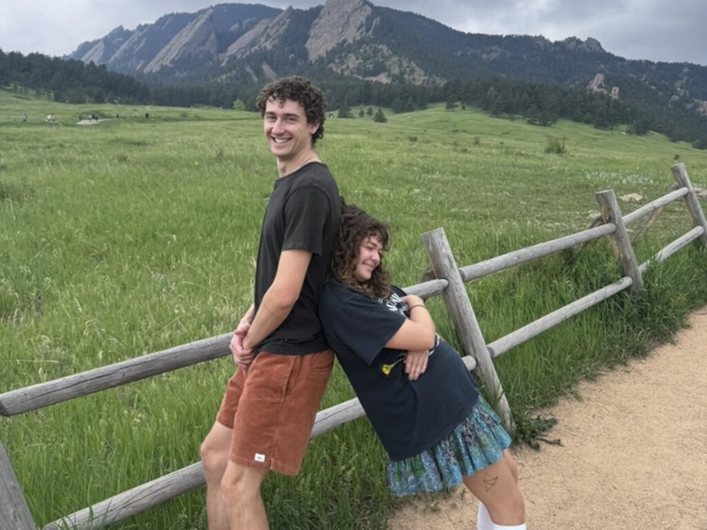 Isaac and Andi, founders of The Frosty Cone, smiling on a mountain trail in Colorado