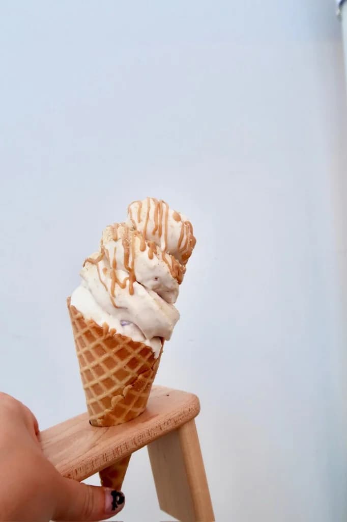 Vanilla real fruit ice cream cone with caramel drizzle