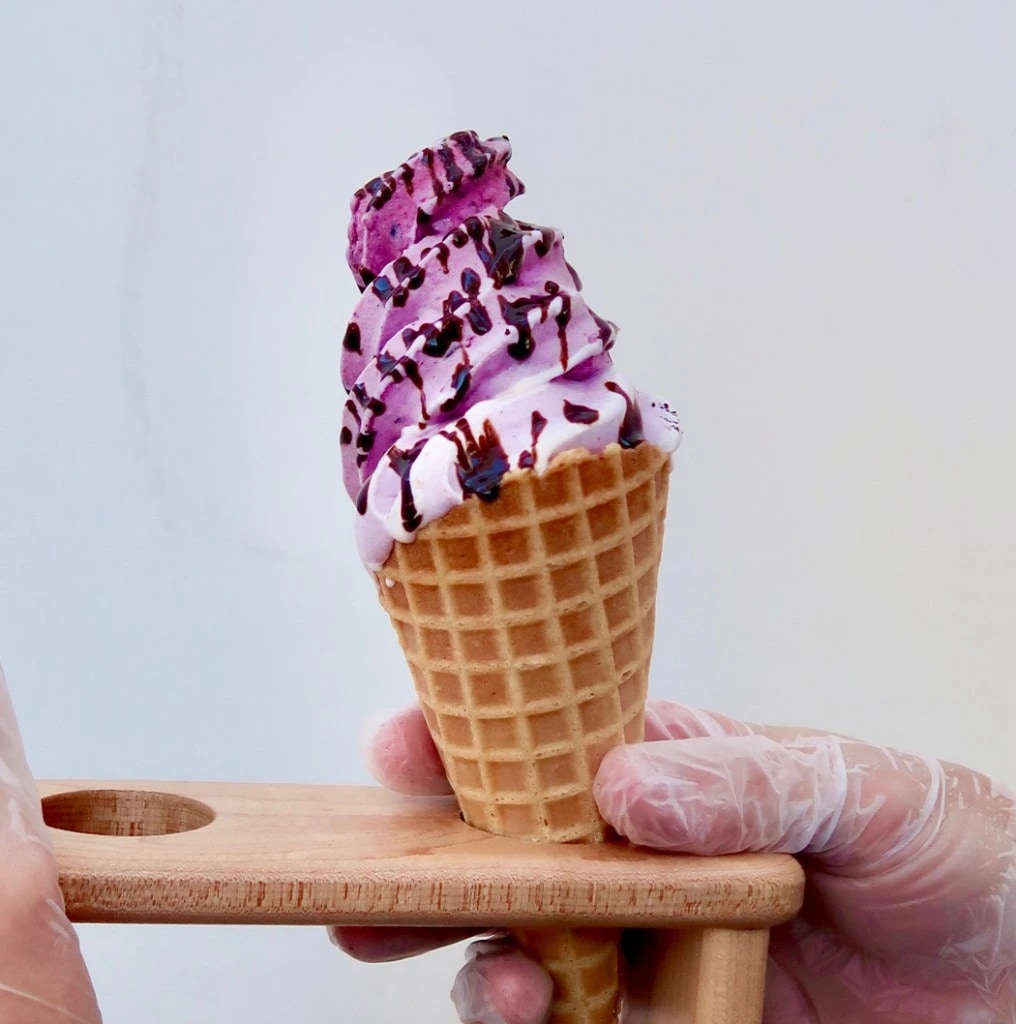 Purple berry real fruit ice cream in a waffle cone